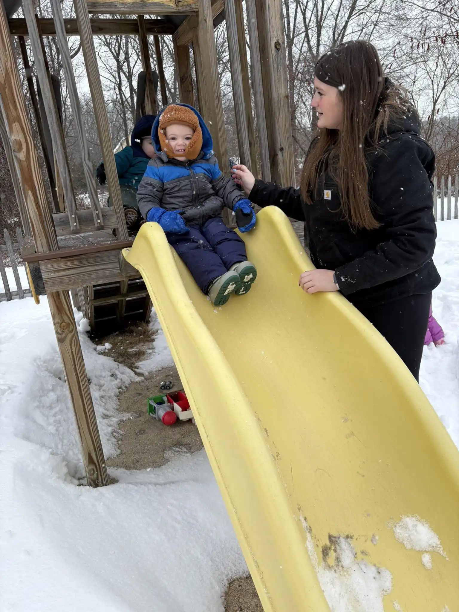 Winter outdoor play — sliding at the playground