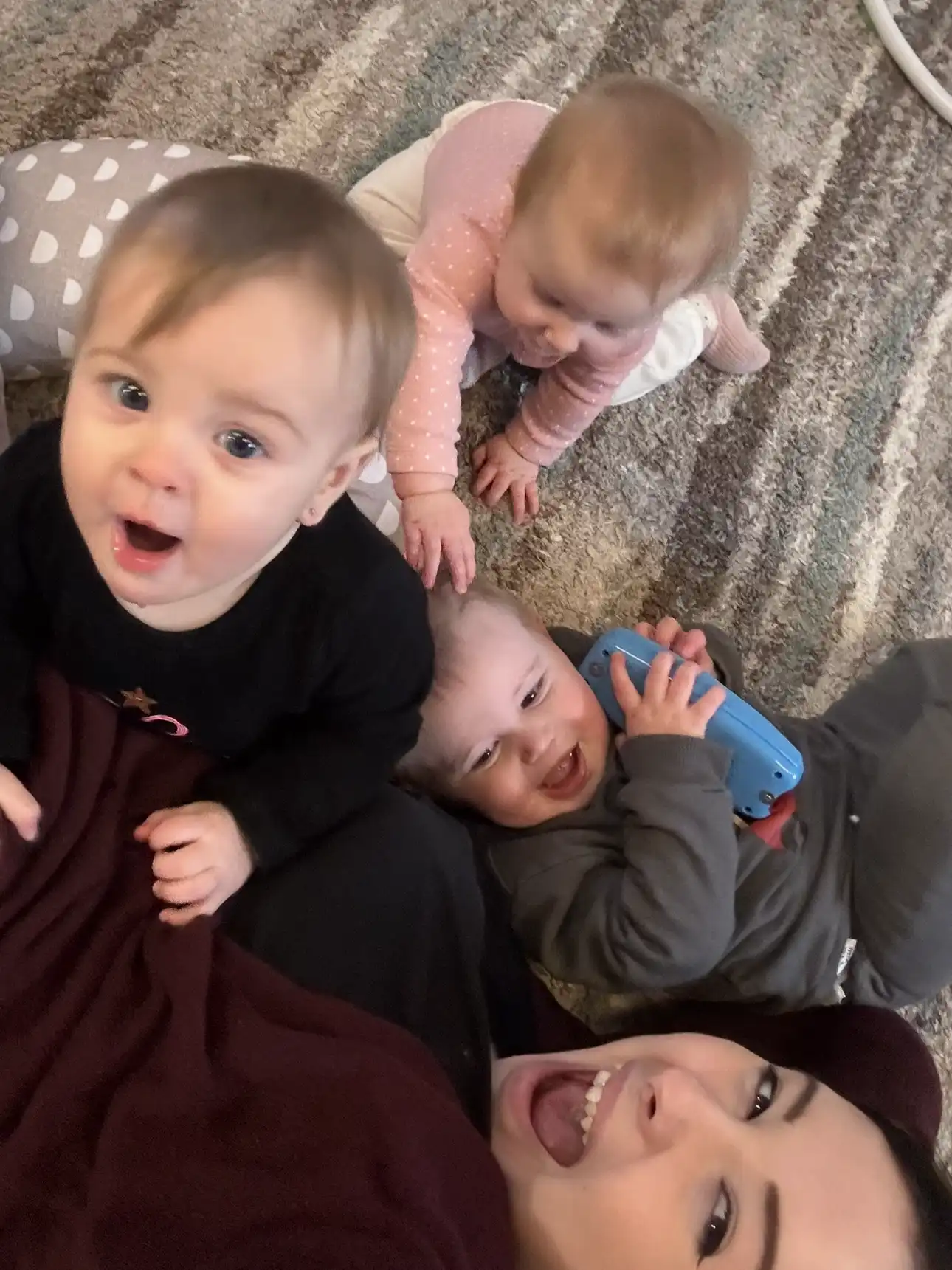 Caregiver on the floor with three babies