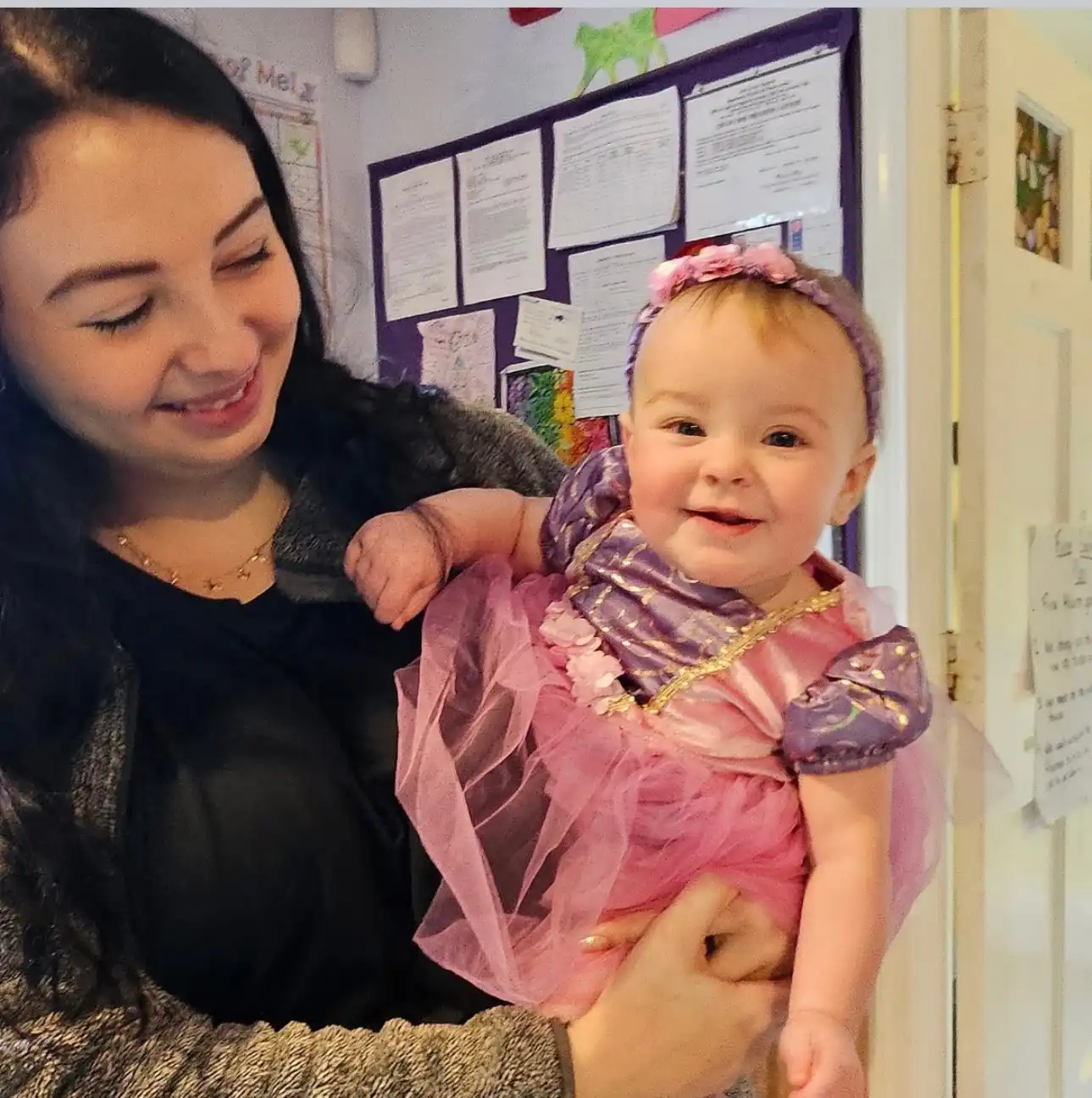 Baby in a princess costume with caregiver